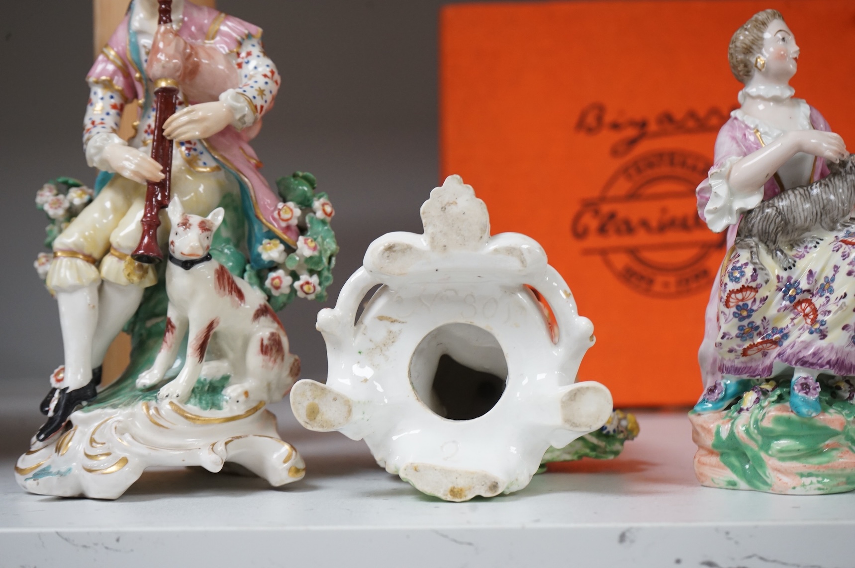 A pair of Derby porcelain figures of musicians, and another of a lady and cat, late 18th century, largest 18cm high